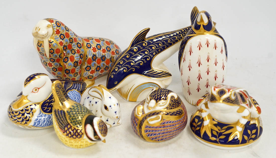 Eight Royal Crown Derby porcelain paperweights in the form of animals including a penguin, rabbit and seal, largest 17cm wide. Condition - seven good, one broken